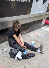 One Track Mind: an addict gets his fix on 35th Street between 8th and 9th Avenues; the Midtown South precinct house sits mid-block.