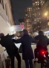 A biker second after driving onto a sidewalk and sucker punching a British tourist after the man used an umbrella to prevent the biker from hitting them as they crossed an intersection at Third Ave. and E. 69th St.