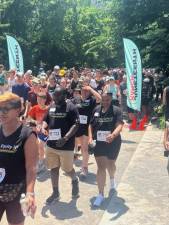 Participants in 2024’s Juneteenth March, which is now a 5K, racing from the starting gate at Central Park’s Engineer’s Gate.