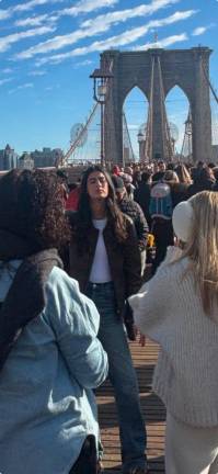 People stopping to pose for photos seemed more of an impediment to the human parade on the bridge than the handful of unlicensed vendors on the Brooklyn Bridge on a warm New Year’s Eve afternoon.