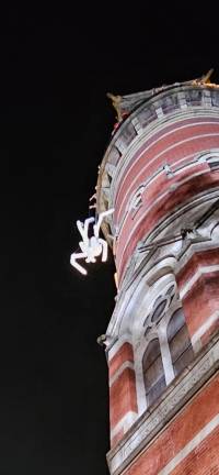 A closeup of “Zohra” the marionette spider hanging above the Halloween parade.