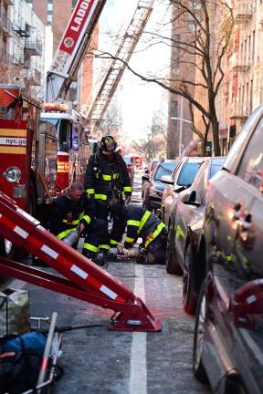 Firefighters responding to a three-alarm blaze at 160 E. 91st St. on Monday, Jan. 27, which tore through 20 units.