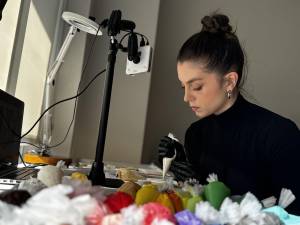 Abbey Kowalec at work on a cookie creation says she considers herself more of an artist than a baker.