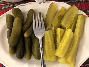 A plate of sweet pickles (left) and dill pickles (right) laid out for a Thanksgiving Dinner.