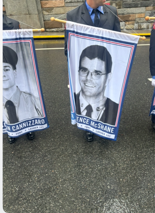 Current FDNY firefighters hold banners with the faces of the 343 firefighters who died on 9-11. Runners see the long line of banners just as they exit the Manhattan side of the tunnel.