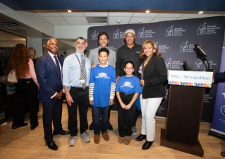 Rangers legend Henrik Lundqvist (rear row left) and Knicks star John Starks (rear row right) gather with staff and patients at Metropolitan Hospital in East Harlem to dedicate two new rooms available to families with kids undergoing cancer treatments.