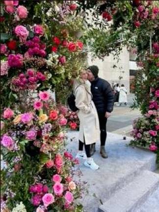 Couples embraced beneath a four column flash flower pop up that had magenta and pink lilacs, peach roses as well as pastel colored statice and some wax flowers. Photo: Jill Brooke.