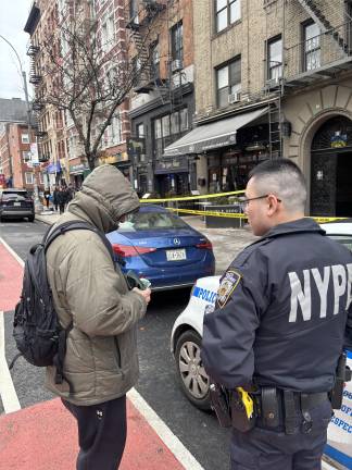 Police check ID of resident Steven Planter, who lived on the fourth floor. Planter knew the 75-year-old man who died and described him as “old school, a stand-up guy.” The cause of the fire is under investigation.