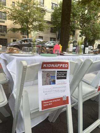 Empty chair for four-year-old girl at the Shabbat table.