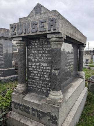 The grave of Eliakum Zunser, and his wife Fannie (Feigel), Washington Cemetery, Brooklyn. The elevated F train to and from Coney Island is in the near distance behind it.