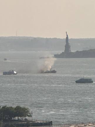 Ferry Father Mychal Judge ablaze, August 29, 2024, with “Lady Liberty” behind.