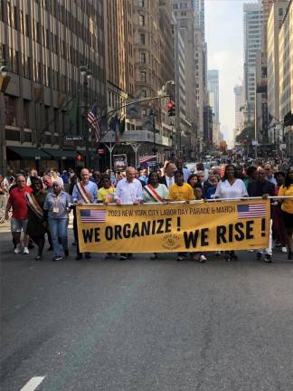 <b>Nancy Hagan, the head of the New York State Nurses Association (center, with sash), the Grand Marshall of the Labor Day parade in NYC, is accompanied by Senator Chuck Schumer in the march up Fifth Ave. on Sept. 9.</b> Photo: Keith J. Kelly