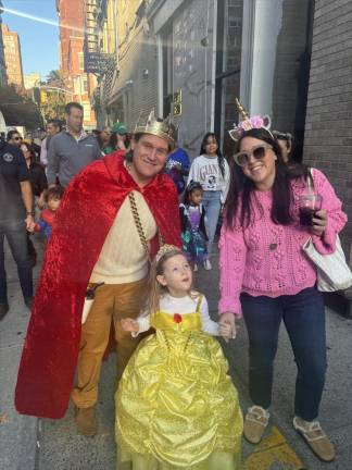 Adults get into the festive spirit at the annual Epiphany Halloween parade.