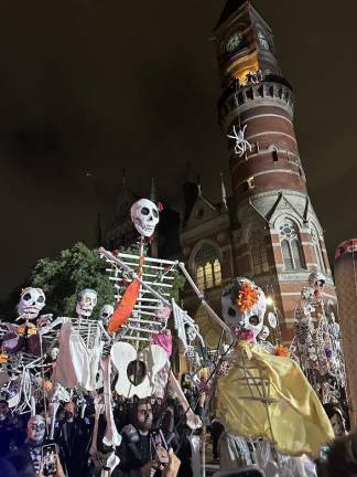 Large skeleton figures march down 6th Avenue exciting the crowd. Skeletons were big at this year’s parade.