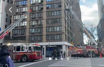 Firetrucks extend ladders as they battle a blaze in a high-rise building on East 45th Street on Feb. 7.