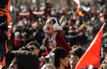 Cold temperatures did not keep this young lady from enjoying the Lunar New Year parade in Chinatown.