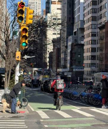 A bicyclist heading north on Third Avenue passes through the intersection at 72nd Street.