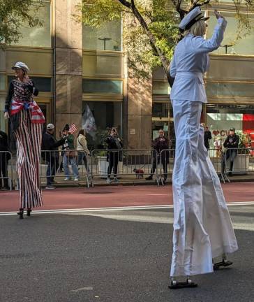 Stilt walkers were a big hit with kids along the parade route of the Veterans Day parade. Photo: Brian Berger