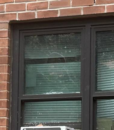 A shattered window reportedly to be caused Trinity School students throwing rocks.