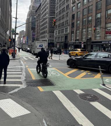 At the intersection of 7th Avenue and W. 38th Street, a rider stops just in time to avoid colliding with a turning car. In this case, the car making a turn should have yielded to the biker going straight. Thirty bike riders died as a result of accidents in 2023 and 400 bikers were seriously injured.