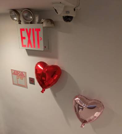 Heart-shaped balloons on TemptationsNYC’s seventh-floor stairs. March 1, 2025.