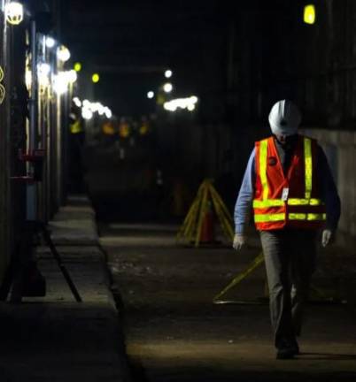 A transit worker walks along tracks on the Second Ave. subway extension under East Harlem that was built in the 70s and halted during the city’s fiscal crisis.