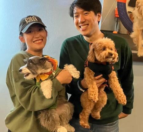 Dog mom Gabby Shi and Bingo, a two year old mini schnauzer, pose with friends.