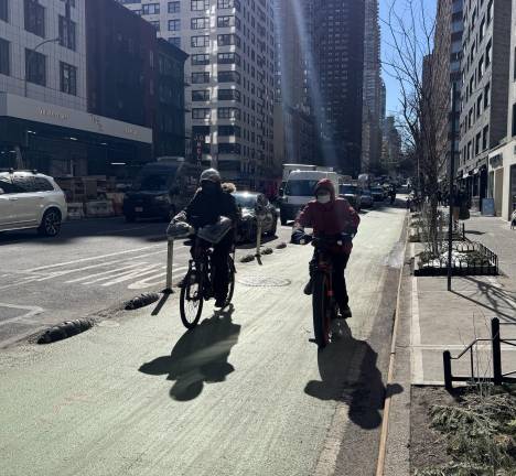 Two delivery drivers moments before getting another green bike light at the intersection of 74th Street and 3rd Avenue. When traveling at 15 miles per hour on an e-bike it is possible to cruise through all 36 blocks of the “green wave” without hitting a single red light.