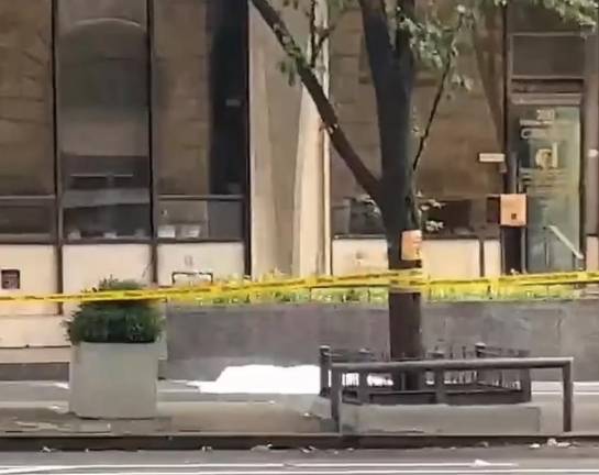 A white tarp seen over the body of a man that leaped from the 17th floor of 200 Central Park South on Wednesday, July 19.