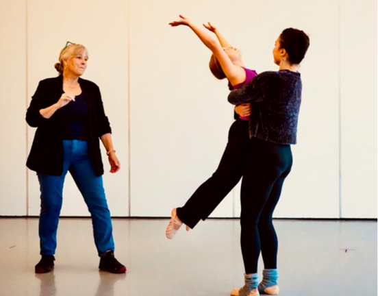 Lydia Johnson (left) watches as Maria Culbreath and Elise Boikess perform in the world premiere of <i>Legacy</i>, set to the minimalist arrangement of Terry Riley’s <i>IN C (1964)</i><i><b>,</b></i>highlighting her signature use of emotion and abstract movement, weaving together deeply human stories.