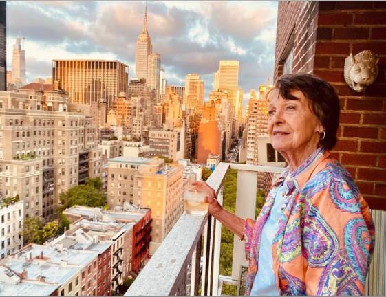 Barbara Maier Gustern, the beloved voice coach who was killed by a crazed young woman in an unprovoked attack on a Chelsea St. in March 2022, seen on her balcony overlooking the city she loved. Photo: Susan Hwang