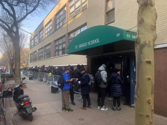 St. Brigid’s School, a shut-down Catholic elementary school in the East Village, drew long lines of asylum-seekers after the city used it as a processing center for people who exceeded 30 or 60 day shelter limits–and were seeking new placements. It is the sole re-processing center for all five boroughs.