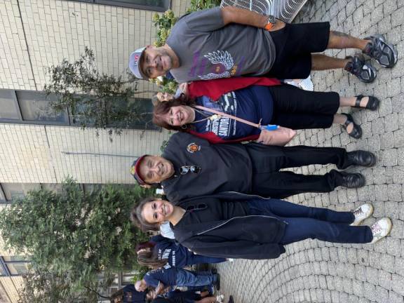 Wendy Feinberg (left) whose father Carl Feinberg died on 9-11, meets up with Al and Maureen Santora (middle two), the father of firefighter Christopher Santora who also died on 9-11 and the Santora’s son-in-law John Cardona.