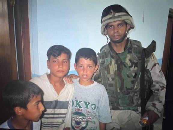 Delivering supplies to kids in Balad, Iraq while Gonell was serving with the US Army.