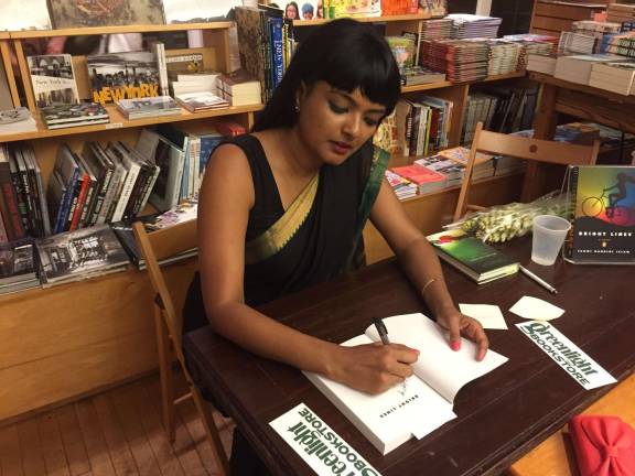 Tanwi Nandini Islam signing a copy of her novel, &quot;Bright Lines&quot; recently. Photo: Bri Hightower