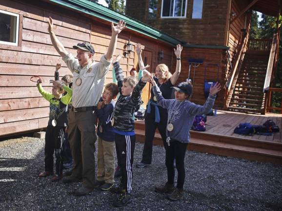 Young kids learn how to react if they encounter a bear in the woods at a camp run by National Park Service.