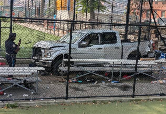 NYPD officer taking pictures of the Corlears Park crash scene, Friday morning July 5.