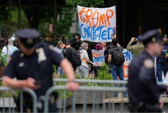 A crowd gathered outside the court house on Center St. in downtown Manhattan shortly after the guilty verdict was announced late in the afternoon on May 30. Photo: AP