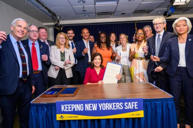 Gov. Hochul and e-bike accident victim Rabbi Miller (second from right) along with other legislators, at the July 11 event where seven new e-bike regulations were signed into law.