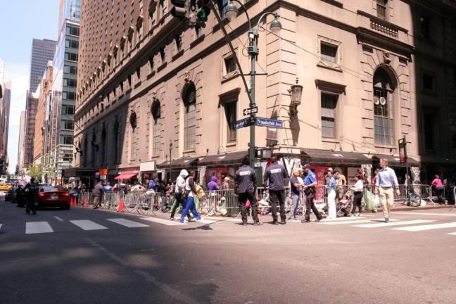 Asylum-seekers queuing up near the Roosevelt Hotel in Midtown Manhattan in July 2023. On Dec. 10, Mayor Eric Adams announced that six migrant shelters in Manhattan would be closing in the next two months as part of a plan to close 25 across the city. So far, the Roosevelt remains a shelter.