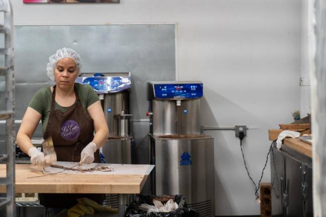 Damarys cleans her tools before the next batch of molds.