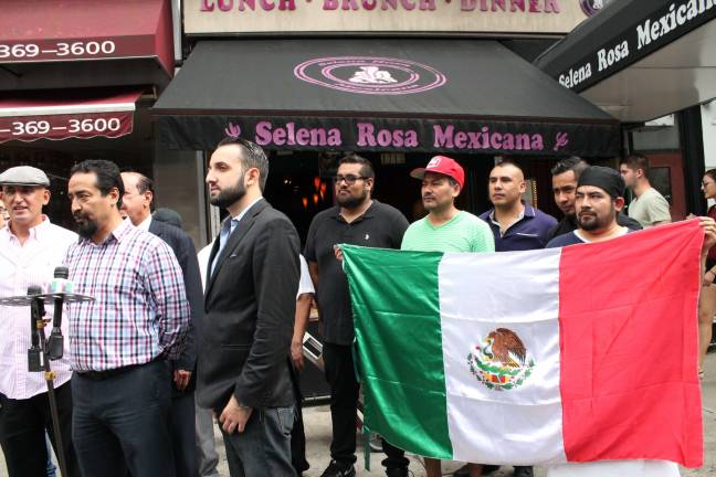 Sammy Musovic (left, with cap), the owner of Selena Rosa on Second Avenue, and Armando Martado (at mic), discuss the settlement of a dispute about the restaurant's name. Photo: Alexandra Zuccaro