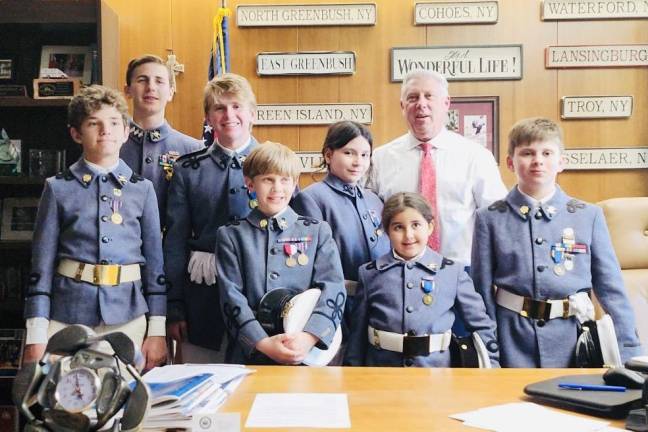 A group of Knickerbocker Greys smile in uniform.