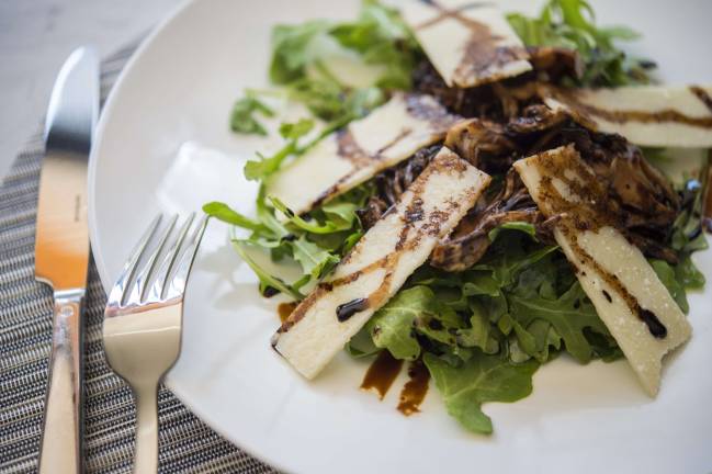 Grilled-hen-of-the-woods mushrooms on a plate at Freds Madison Avenue
