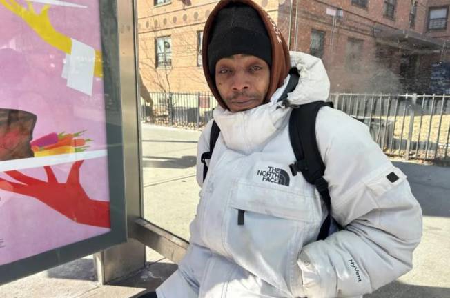 Luis Martinez waits for an M15 bus on Second Avenue in East Harlem, Jan. 9, 2025.