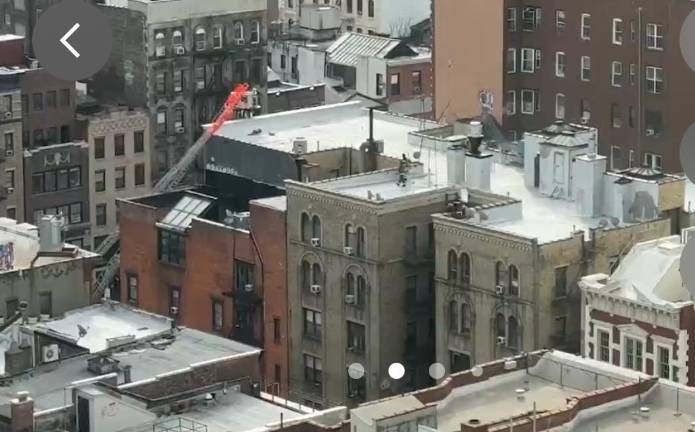 Firefighters seen on roof of building on Second Avenue. on Feb. 2, which was the scene of a fatal fire on the second floor earlier that day.