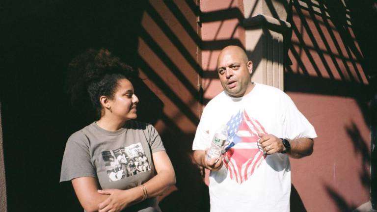 Director Taylor Hosking interviews her godfather Arthur Smith for the film at the Puerto Rican Day Festival.