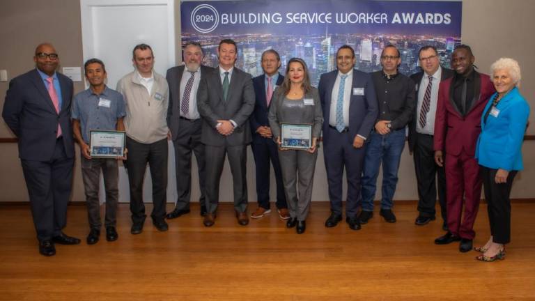 The 2024 Building Service Worker Award Honroees with NY1’s Errol Louis (left) and Straus Media President Jeanne Straus (right) Photo: Steven Strasser