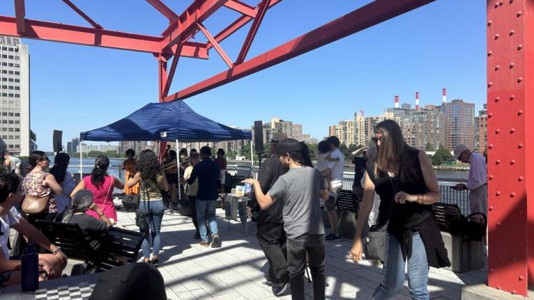 People dancing along to the all women salsa band “Lulada Club,” performing by the East River Waterfront and 60th Street at Andrew Haswell Park on June 1, 2024. Photo credit: Alessia Girardin.