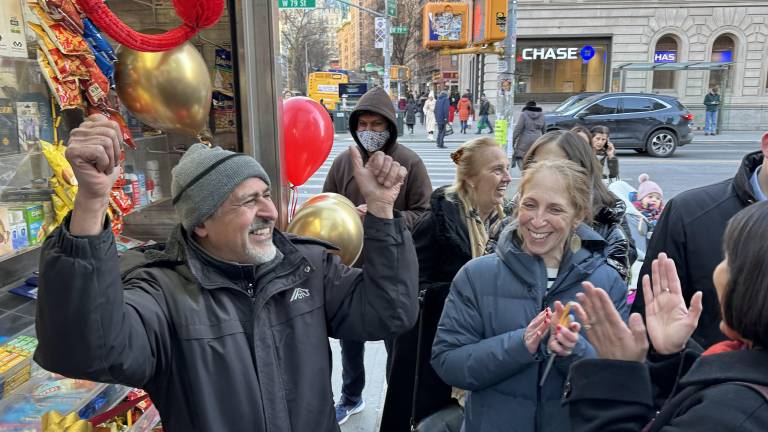 Having just cut the red ribbon and declared victory, Sadik “Sami” Topia cheers and pumps his fists as the crowd cheers for the return of the newsstand, a community fixture on the UWS for over two decades before he ran into fines and ownership issues that forced its temporary closing.